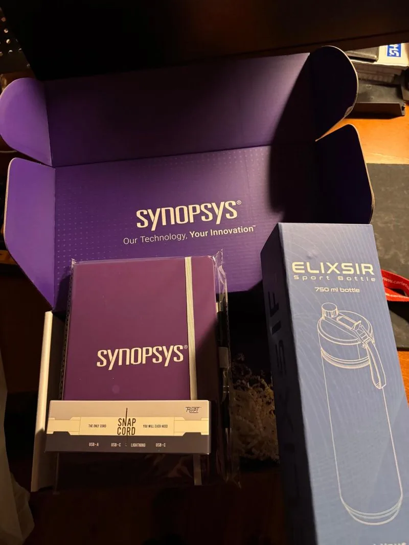 The Synopsys welcome kit: a purple box, a notebook, a cable and a water bottle